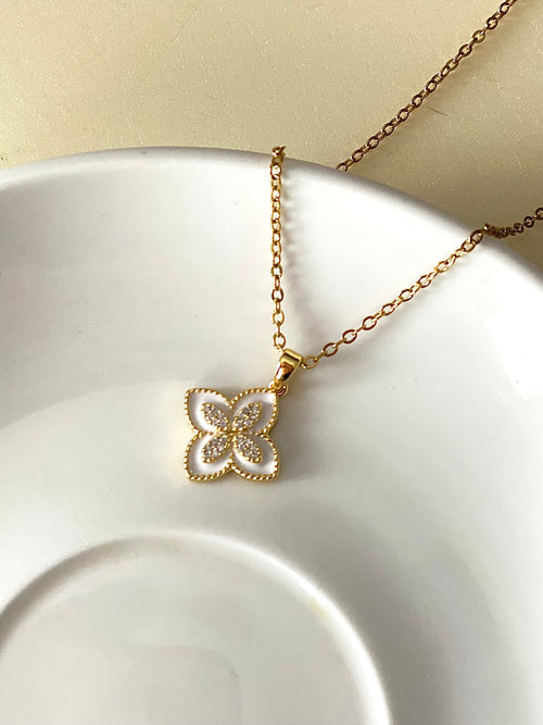 White Lotus gold flower clover pendant necklace on white background by The Adorn Pakistan