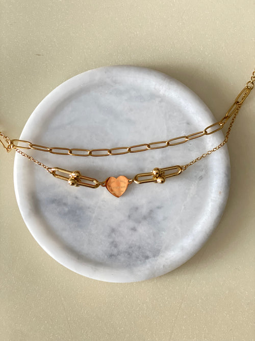 Love Bracelet dainty gold layered bracelet with heart charm on marble by The Adorn Pakistan